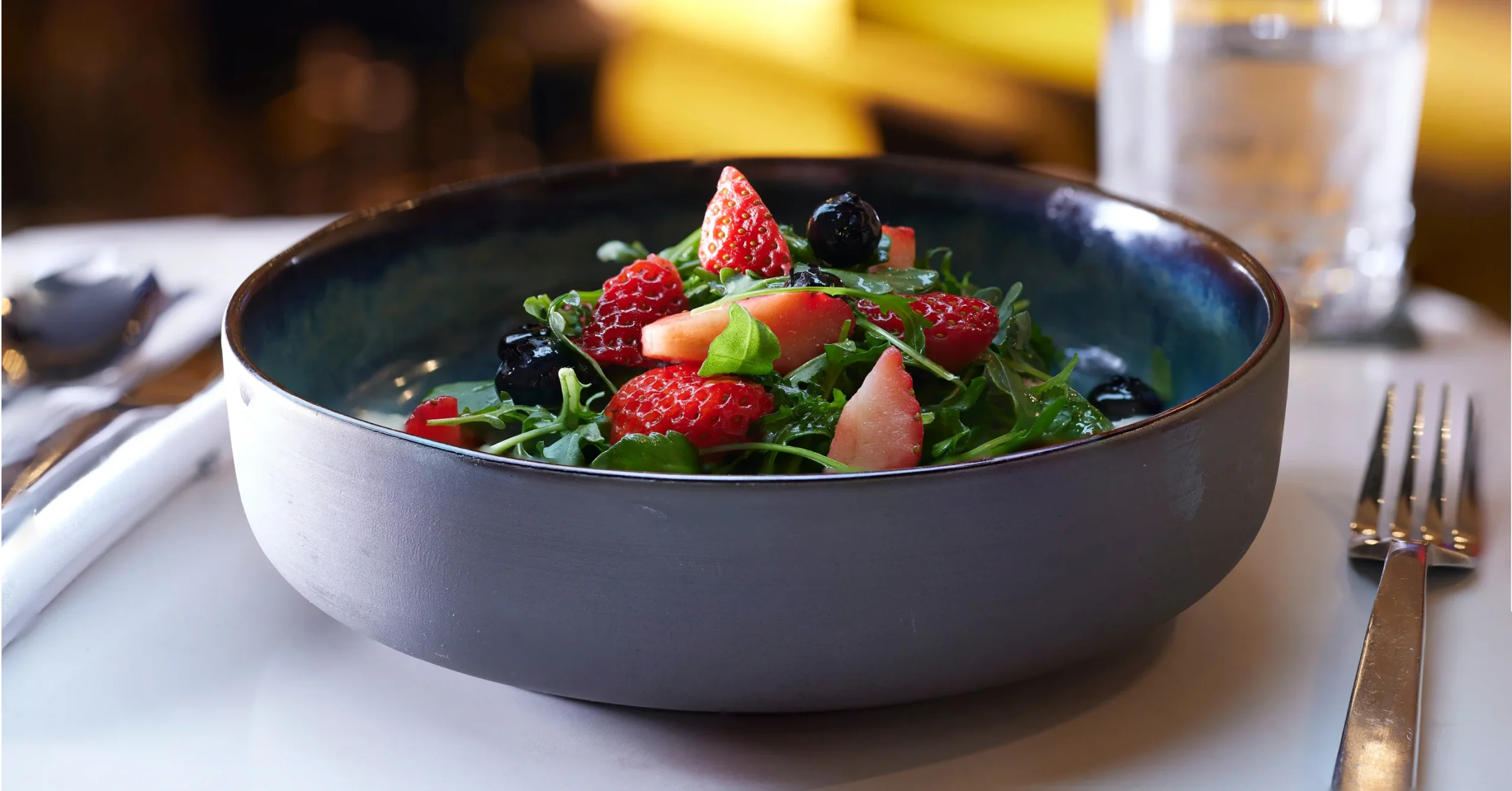 close-up of a salad with strawberries on top